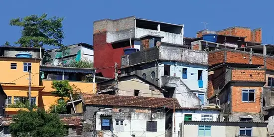 A favela during a sunny day with a clear blue sky