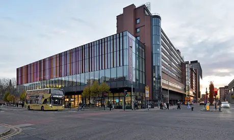 The Alliance Manchester Business School building on the busy Oxford Road in Manchester