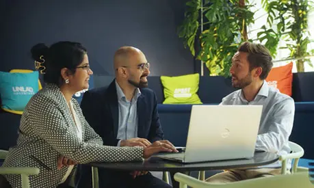 Two MBA students talking with a LADbible employee