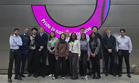 14 young professionals standing outside UBS building.