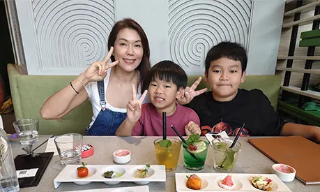 Rena Ho eating dinner with her children.