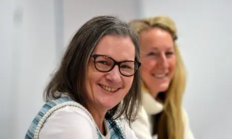 Two women smiling in classroom