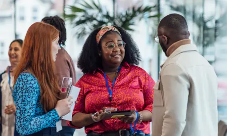 A group of mixed age professionals networking at a conference