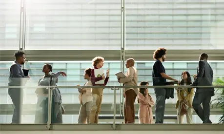Multiracial group of business professionals discussing with each other during seminar at convention center