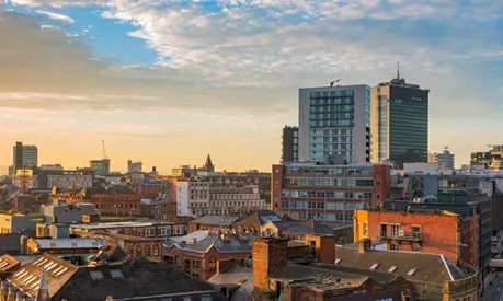 A view of the Manchester City centre skyline at sunset