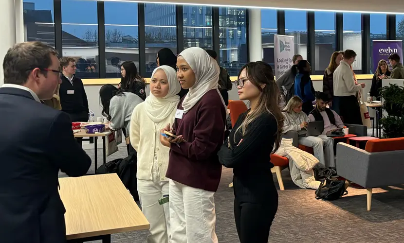 Three accounting students talking with an industry professional