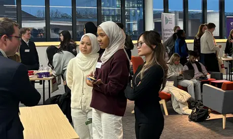 Three accounting students talking with an industry professional