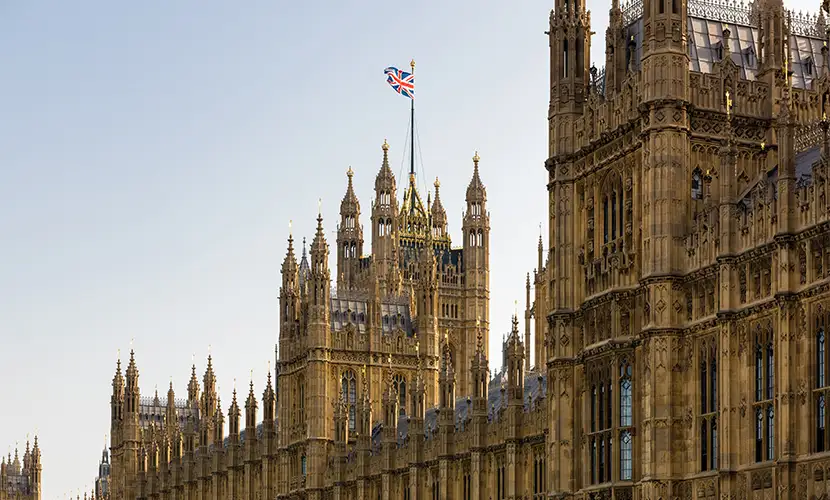 View of the Houses of Parliament with a Union Jack flag