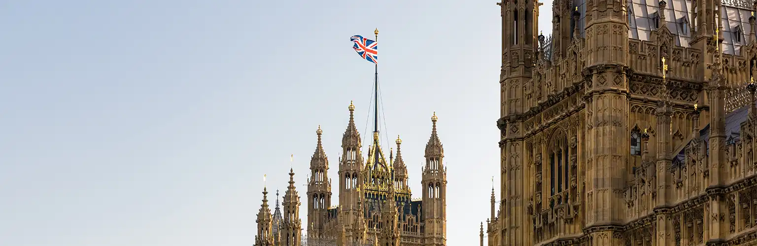 View of the Houses of Parliament with a Union Jack flag