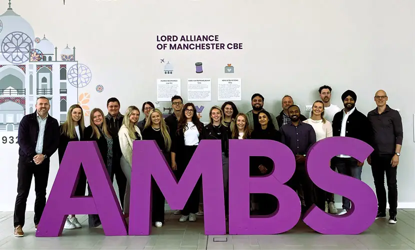 Delegates of the Chiesi customised programme posing together with big 'AMBS' letters in front of them