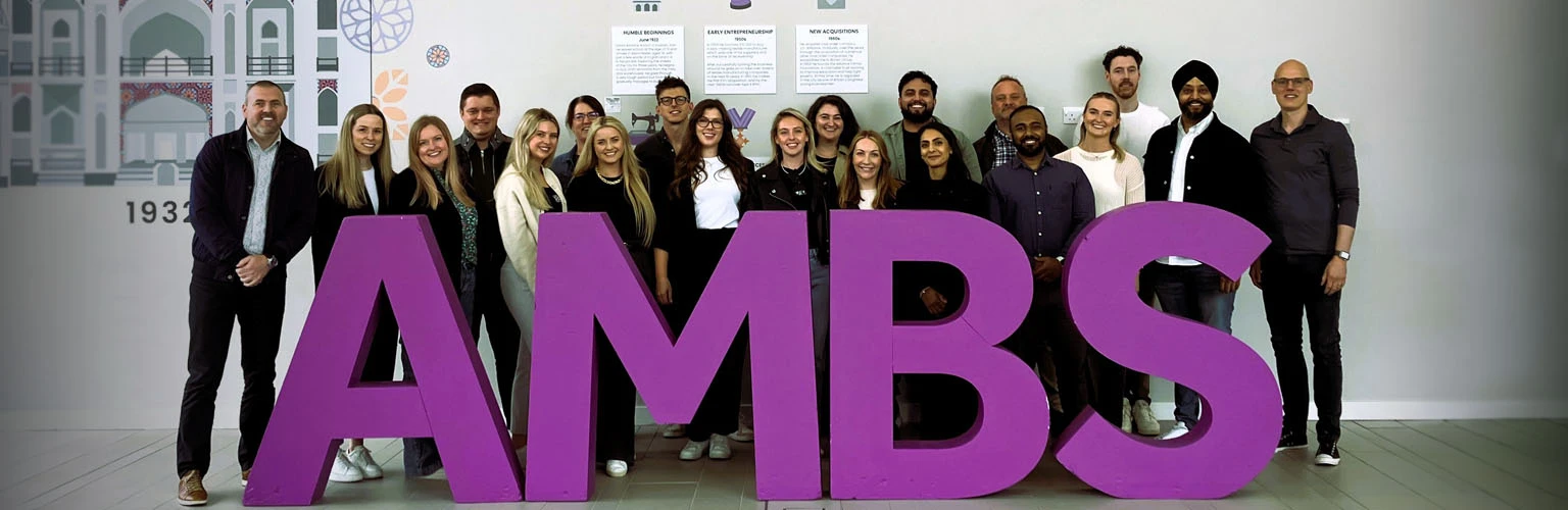 Delegates of the Chiesi customised programme posing together with big 'AMBS' letters in front of them