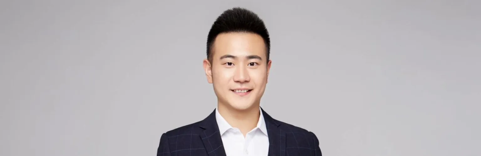 A professional headshot of Arthur Huang