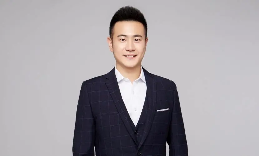 A professional headshot of Arthur Huang